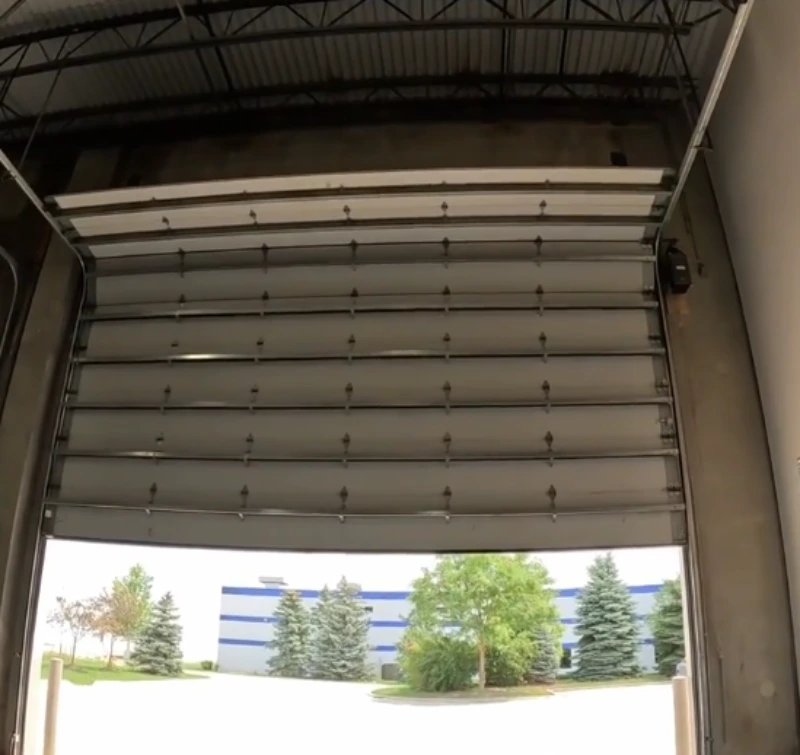 Technician servicing a commercial garage door at a Rio Rancho business