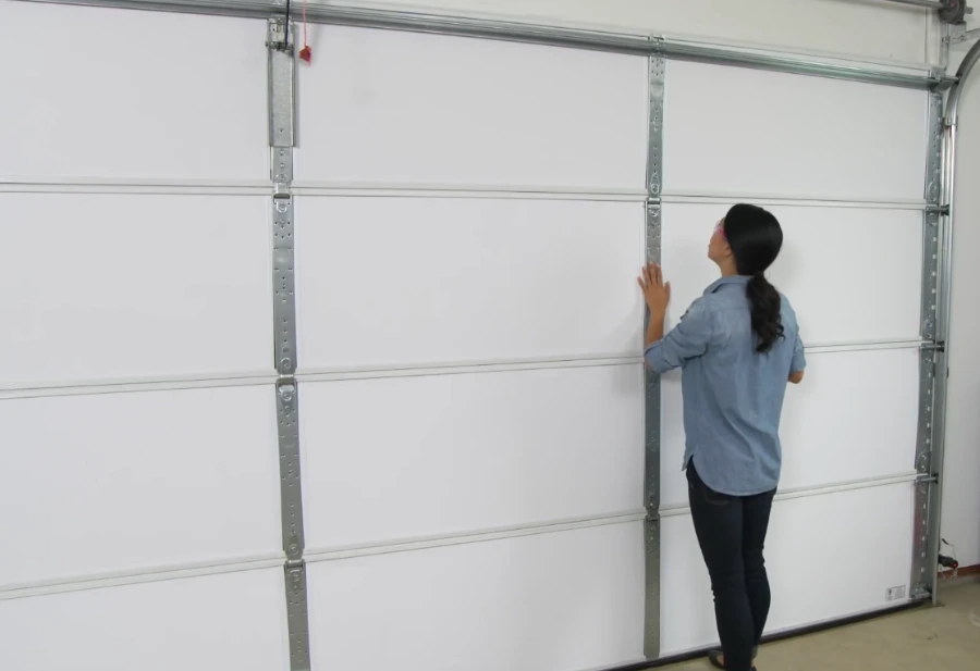 Technician servicing a residential garage door